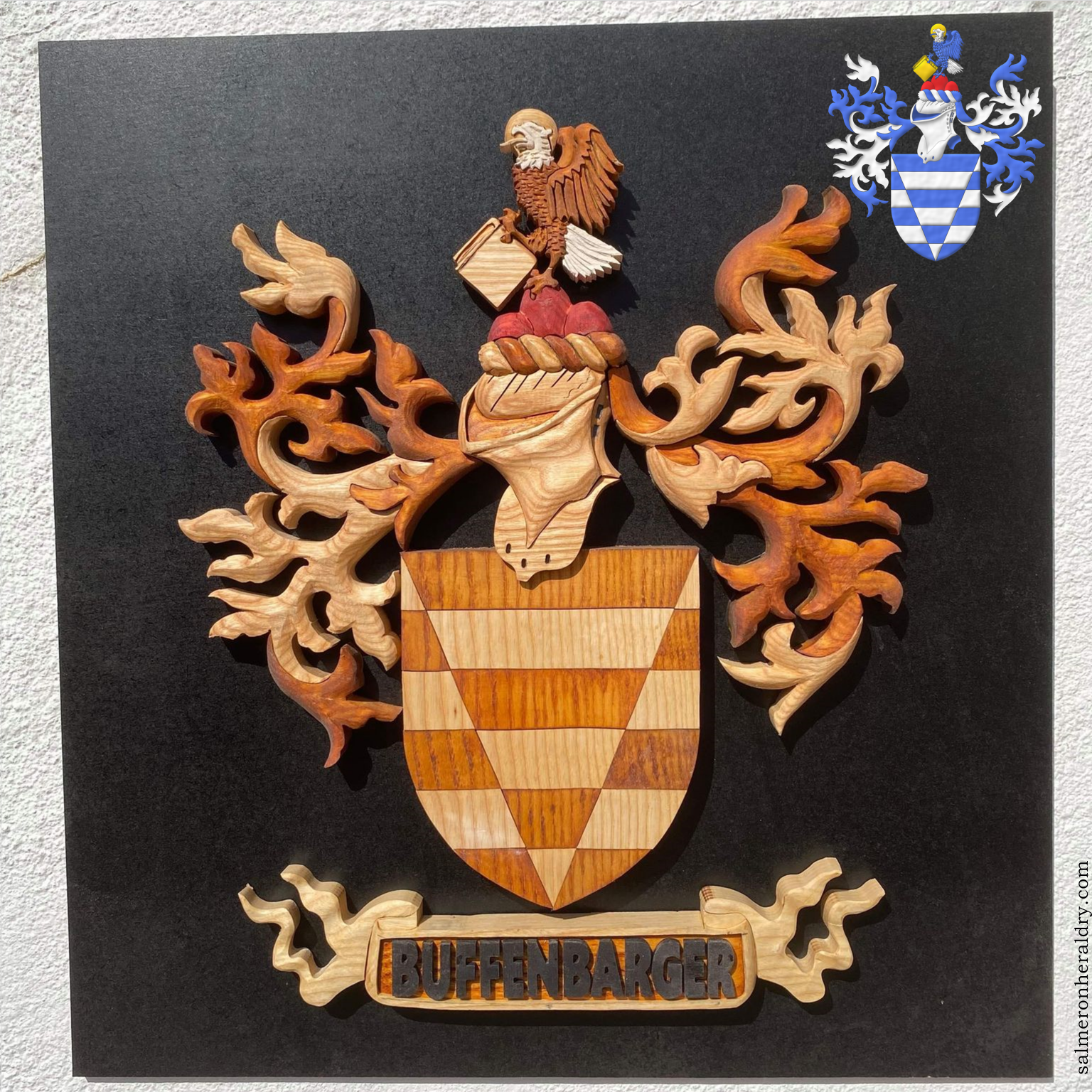 Barry of six, Argent and Azure, a pile throughout, counterchanged. Crest: Upon a trimount Gules, an eagle wings addorsed and inverted Azure, the head and tail Argent, nimbed Or, grasping a closed book also Or. Mantling: Azure doubled Argent. Motto: «Buffenbarger»